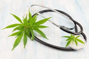 image of a stethoscope with weed leaves wrapped around it, showing that medical marijuana is legal in some states but insurance companies medical marijuana coverage is nonexistent