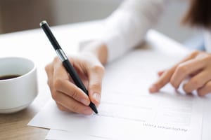 close up of a woman completing an application form