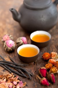 image of two tea cups with no handles filled with tea