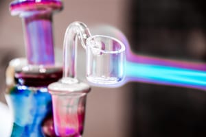 image of a dab rig being heated with a blow torch that is partially out of frame
