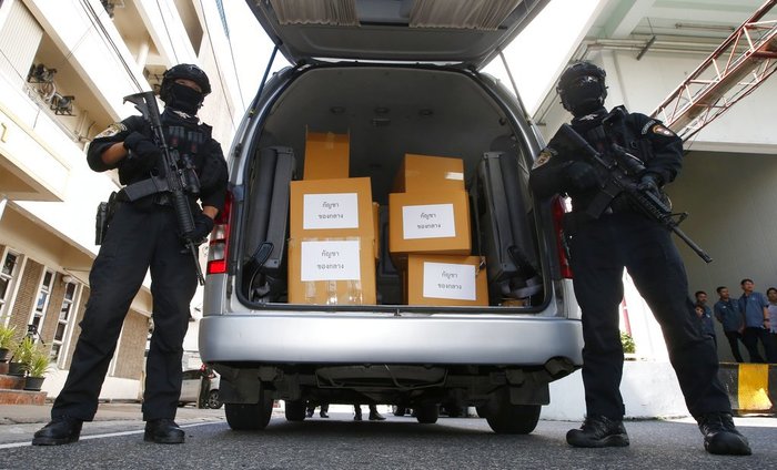 Thailand Medical Marijuana Thai policemen stand guard next to 100 kilograms of seized marijuana before a news conference Bangkok, Thailand, Tuesday, Sept. 25, 2018. Thai police handed over around 100 kilograms of seized marijuana to be used for medical research Tuesday, as officials seek to produce pot-based medication. (AP Photo/Sakchai Lalit)