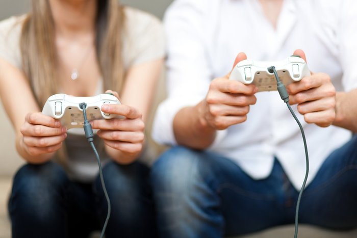 image of a man and a woman playing video games