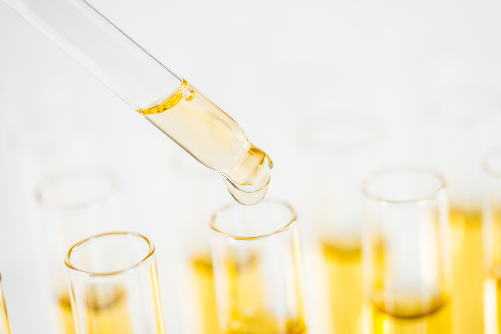 dropping cbd oil into tubes for research