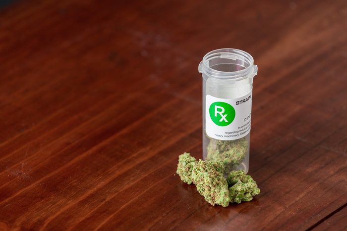 bottle of marijuana on wood table